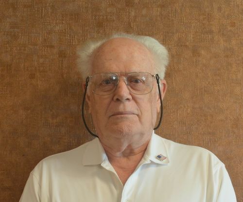 A man wearing a black shirt with the word digital on it