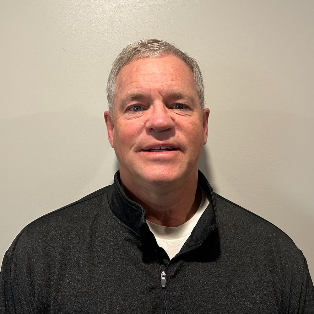 A man wearing a black shirt with the word digital on it