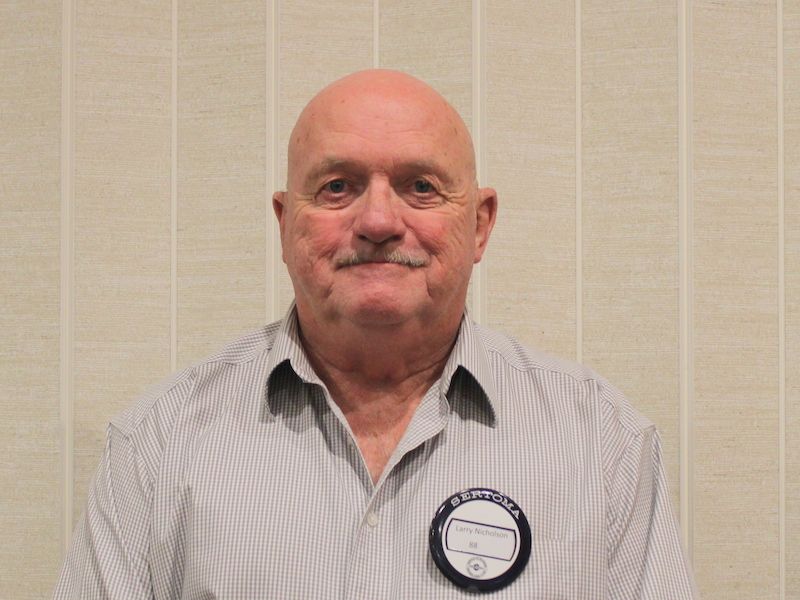 A man wearing a black shirt with the word digital on it