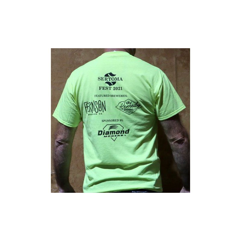 A man is wearing a neon green t-shirt that says seetopia fest