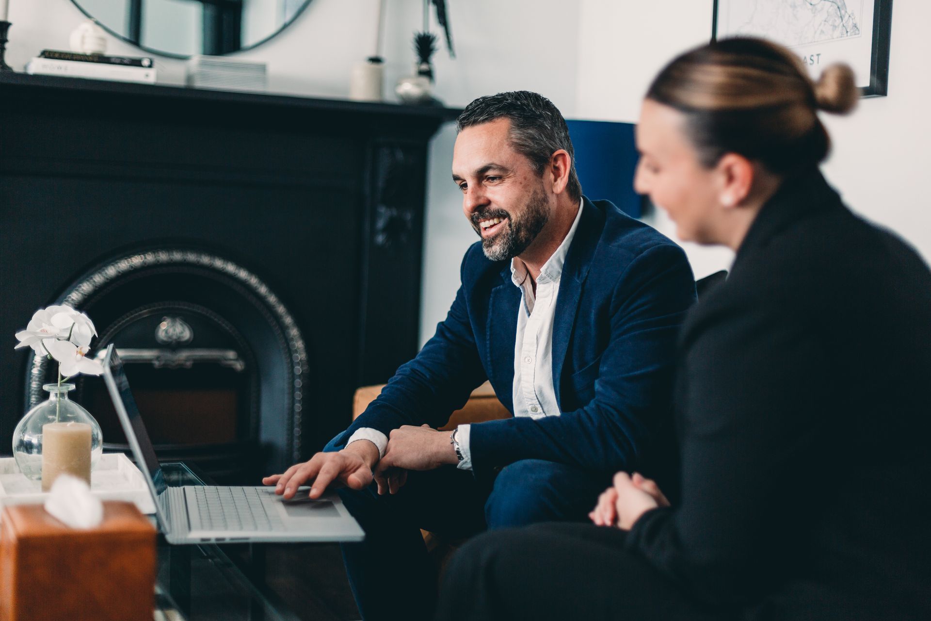 Person Typing on Laptop With Another Person Pointing at Documents on a Table — Slack-Smith Partners In Melbourne, VIC