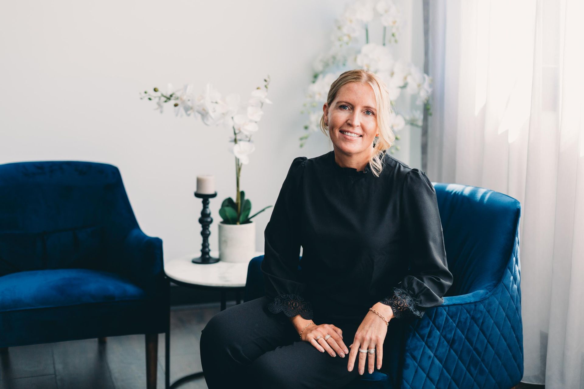 Woman is Sitting in a Blue Chair in a Room — Slack-Smith Partners In Moree, NSW