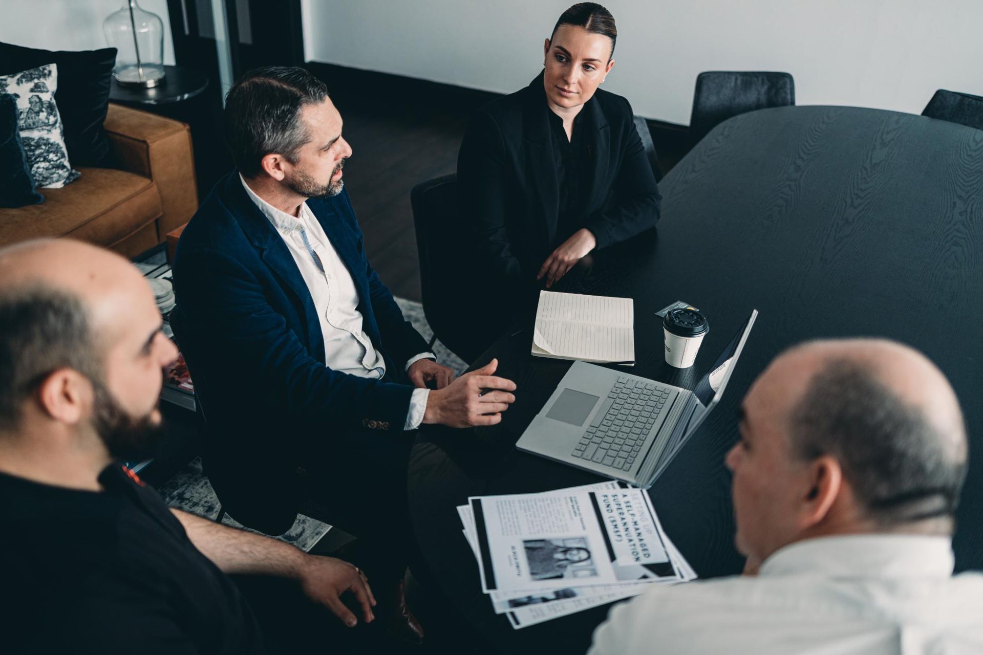 A Group of People Are Sitting Around a Table Having a Meeting — Slack-Smith Partners in Sydney, NSW