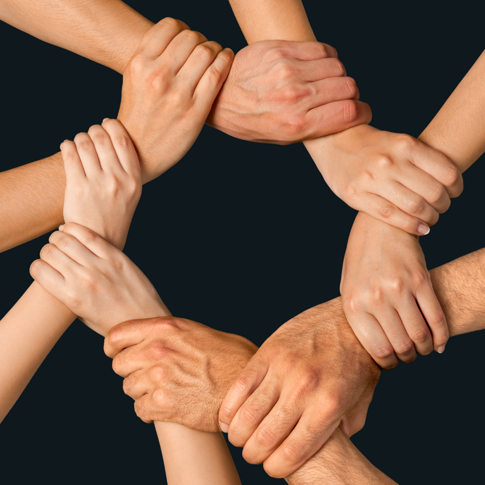 A Group of People Are Holding Hands in A Circle — Slack-Smith Partners in Tamworth, NSW