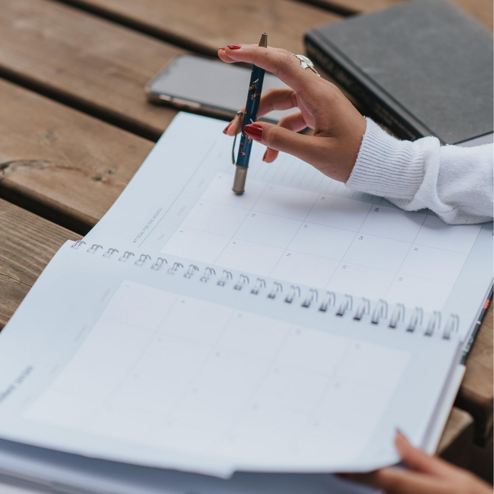 A Person Is Writing in A Notebook with A Pen — Slack-Smith Partners in Tamworth, NSW