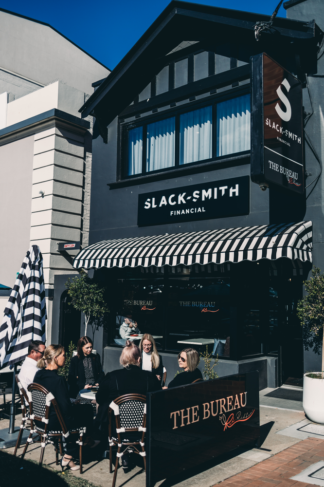 A Group of People Are Sitting Outside of A Restaurant — Slack-Smith Partners in Tamworth, NSW