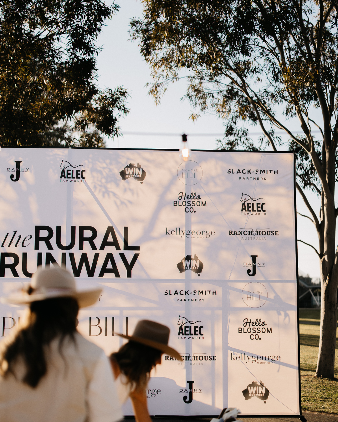 Two People Near a White Banner That Says — Slack-Smith Partners in Tamworth, NSW