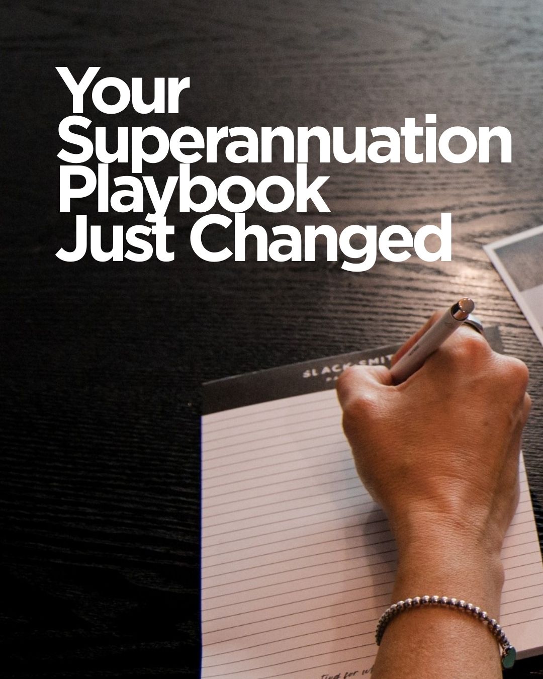 Person writing on a notepad with text