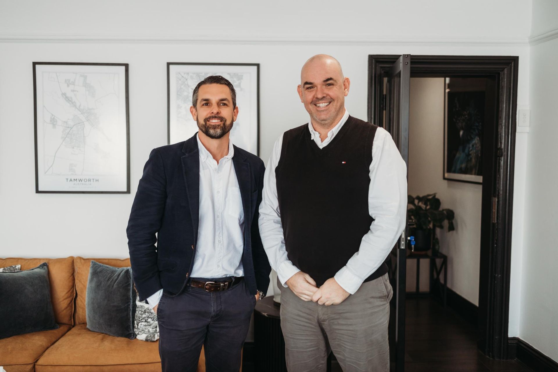 Two Men Are Standing Next to Each Other in A Living Room — Slack-Smith Partners in Tamworth, NSW