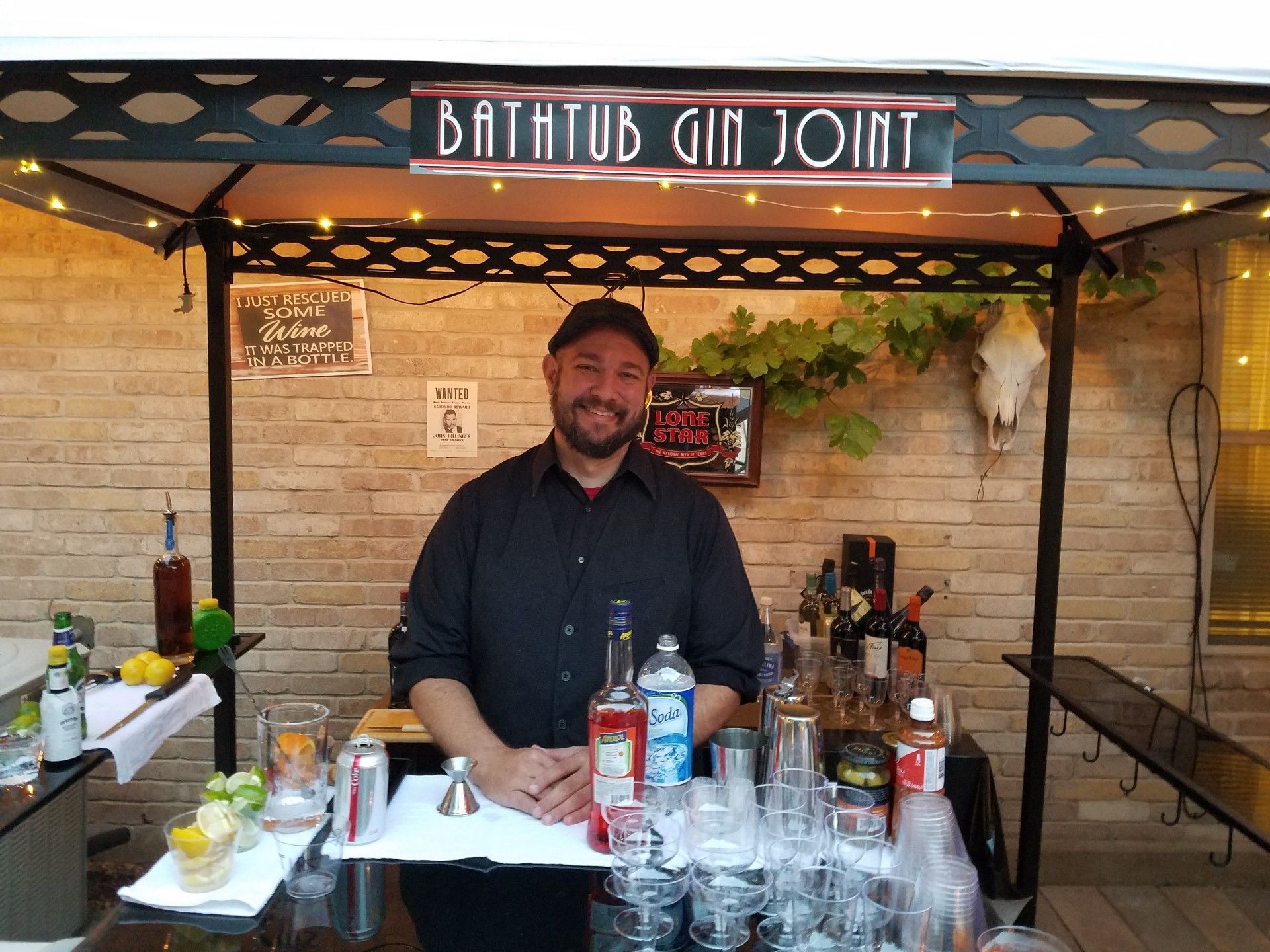 Bartender at outdoor bar labeled 