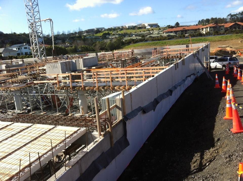 Construction site with concrete forms, rebar, and safety cones. Construction site with concrete forms, rebar, and safety cones.
