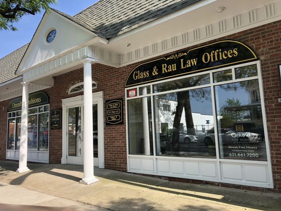 a brick building with a sign that says glass & rau law offices on it .