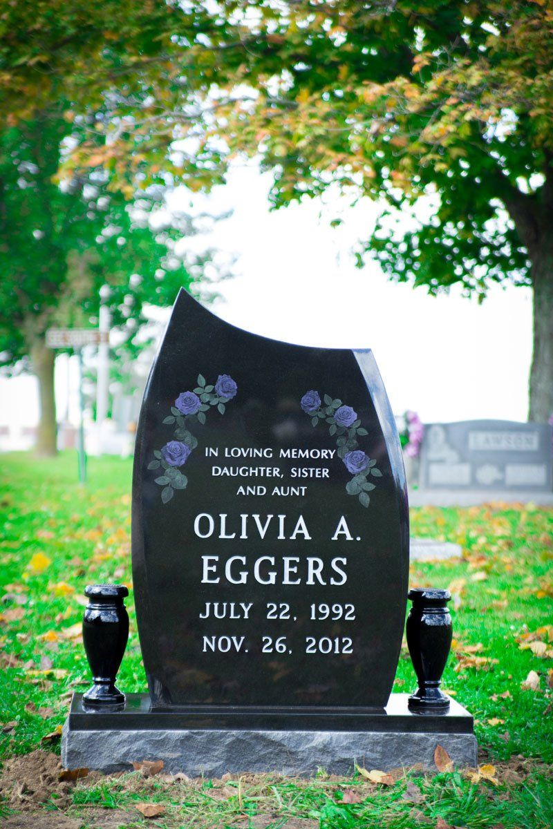 Flat Markers — Black tombstone with floral design in Columbus, Oh