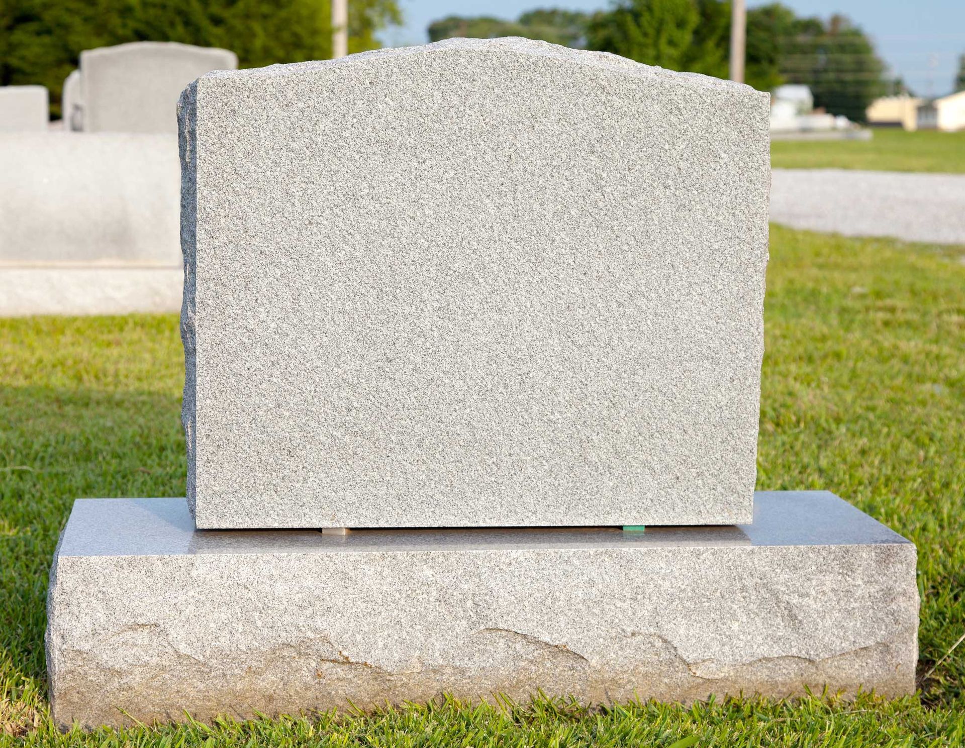 Graveyard scene with a tombstone, showcasing headstone markers for remembrance purposes.