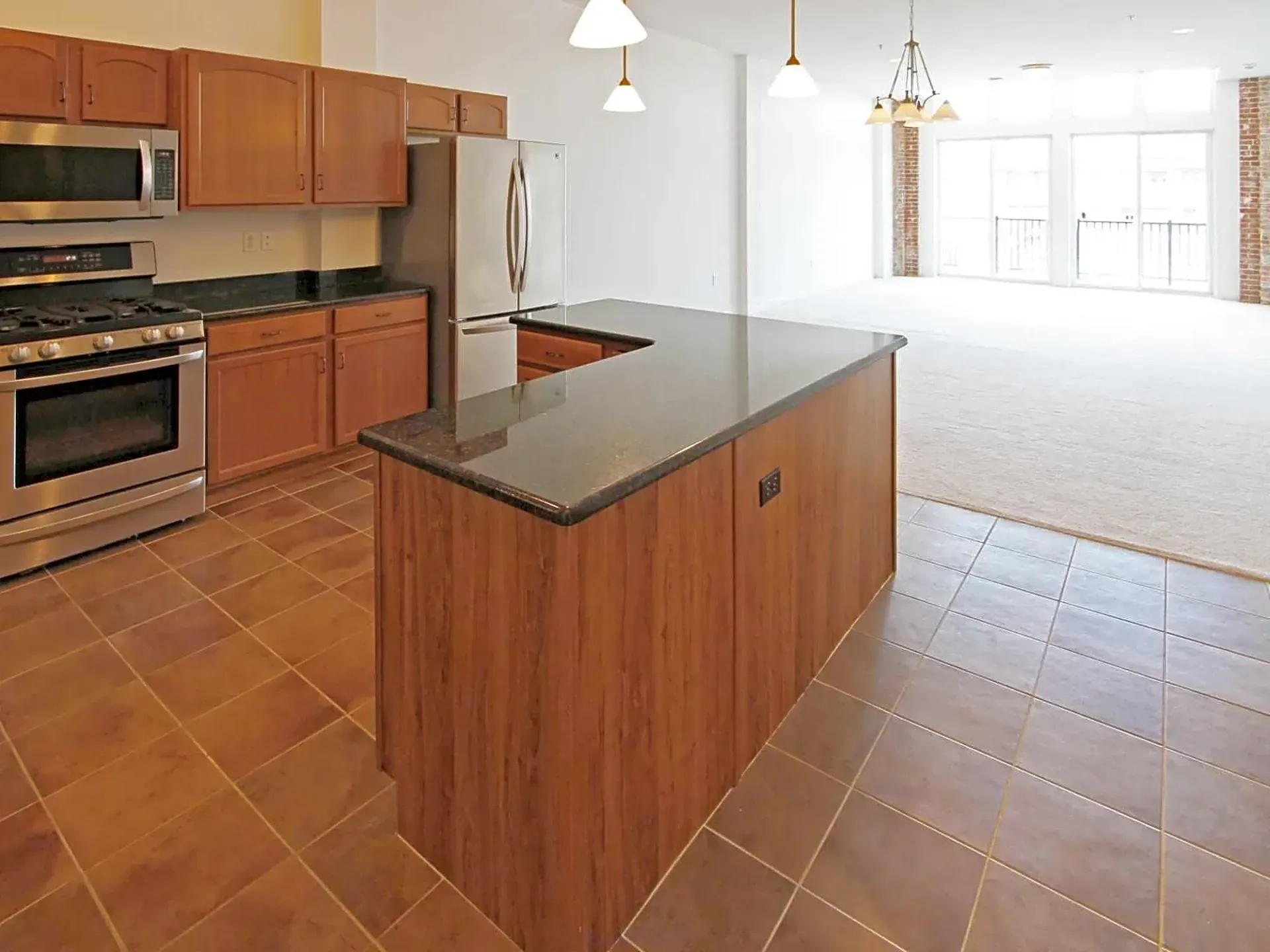 A kitchen with stainless steel appliances and wooden cabinets