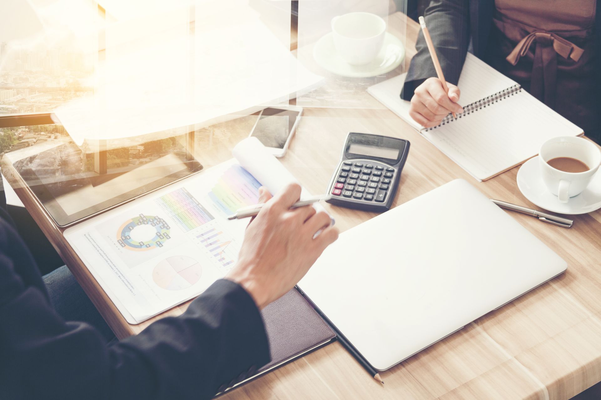 A Man and a Woman Are Sitting at a Table With a Laptop and a Calculator — Murphy Finance Solutions–Darwin & Palmerston In Zuccoli, NT