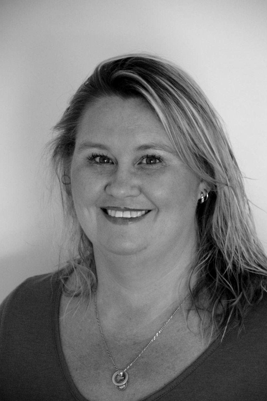 Smiling woman with blonde hair wearing a dark top and necklace against a plain background — Murphy Finance Solutions–Darwin & Palmerston In Zuccoli, NT