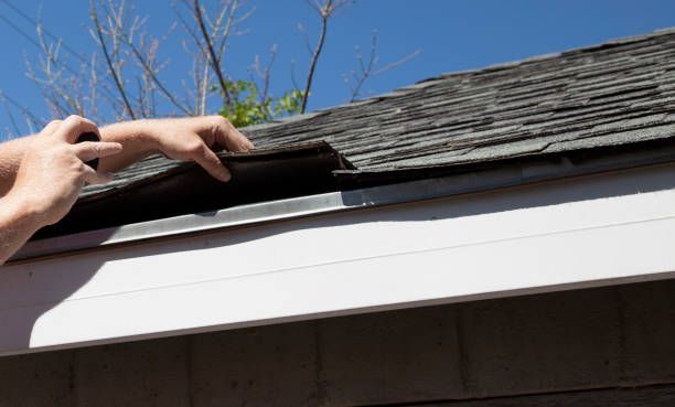 A Photo Of Hand And Gutter — Clayton, WI — Stuivenga Roofing