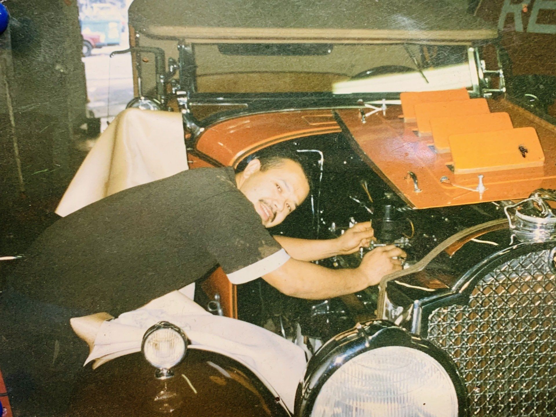 Carlos working on car