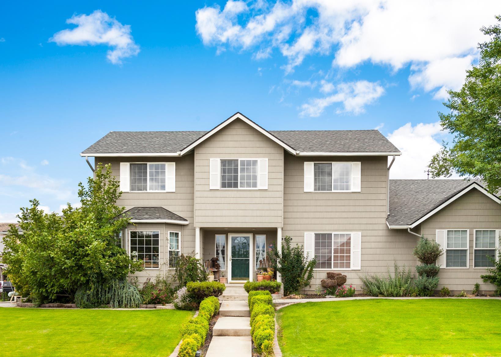 A large house with a lush green lawn in front of it