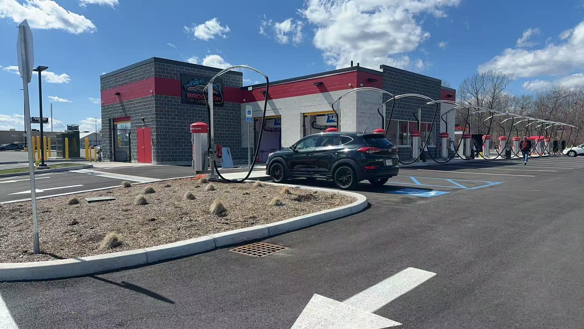 A car is parked in front of a car wash.
