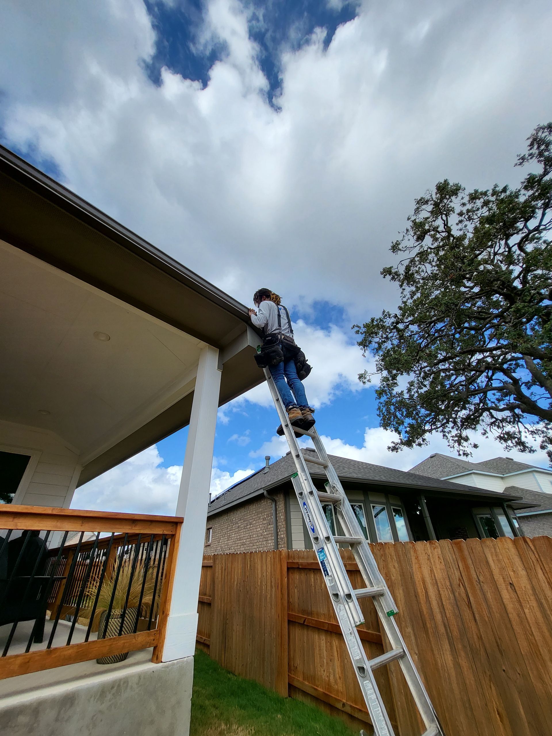 Advanced Seamless Rain Gutter Solutions crew on latter rain gutter installation