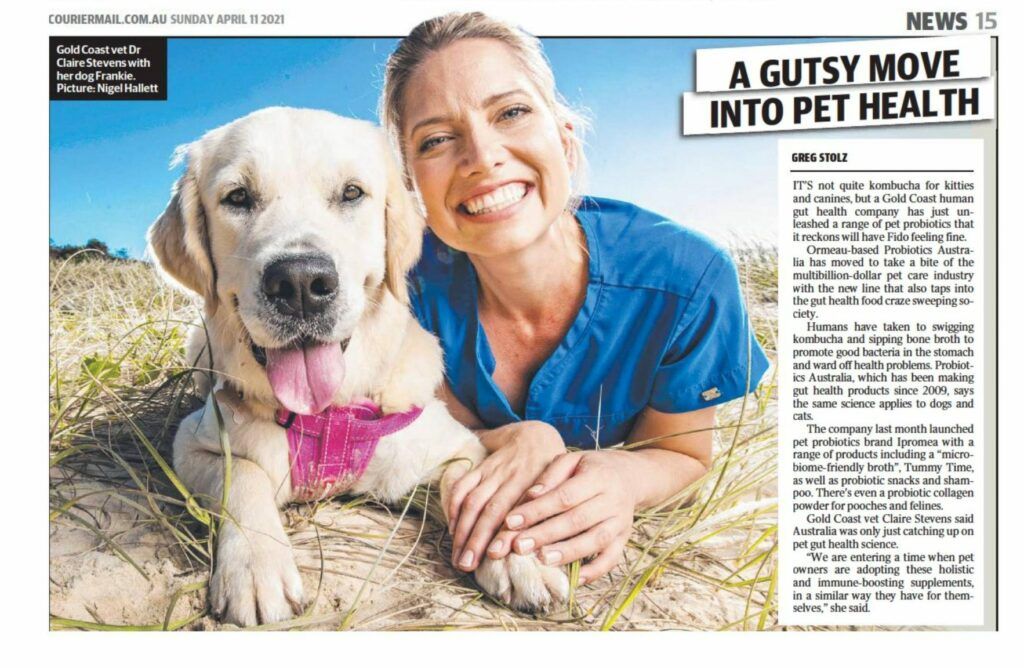 A woman is laying next to a dog in a newspaper article.