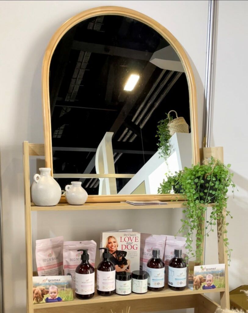 A shelf with bottles and a mirror on it