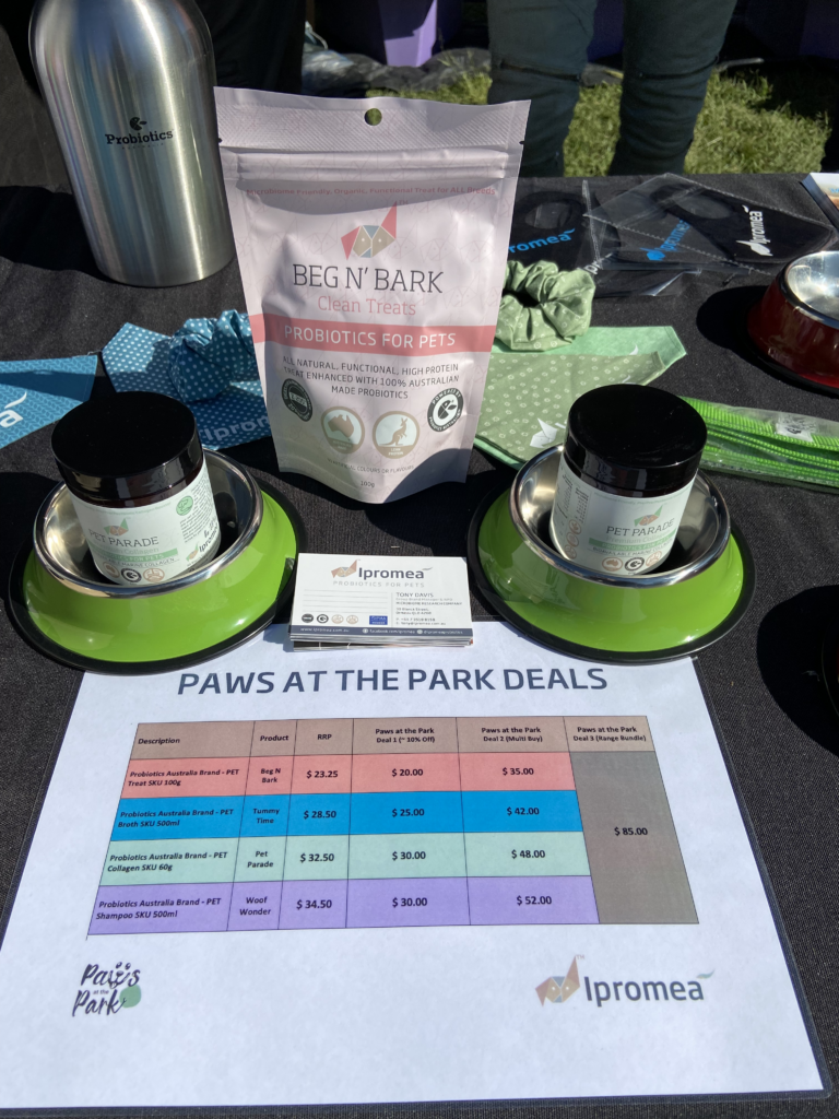 A table with bowls and a bag of food on it.