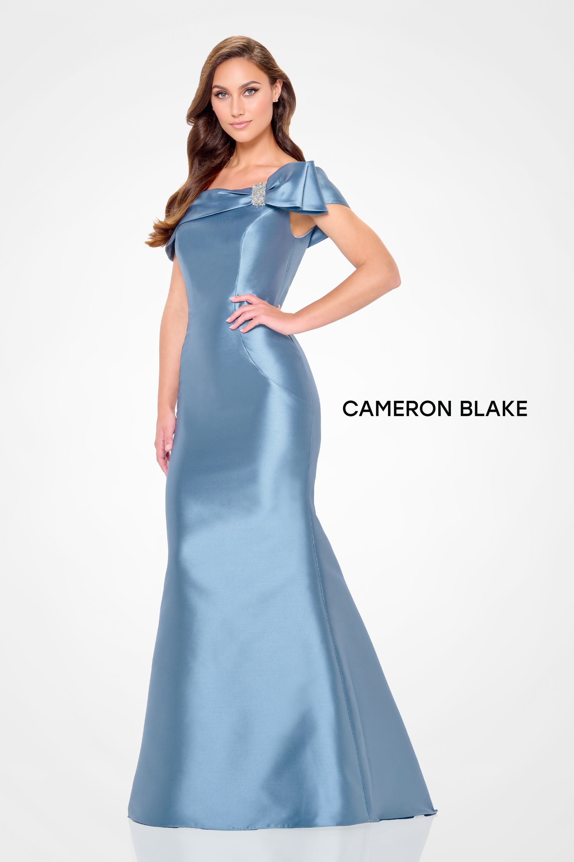 Blue satin floor-length formal gown with ruffled cap sleeves on a model against a white background