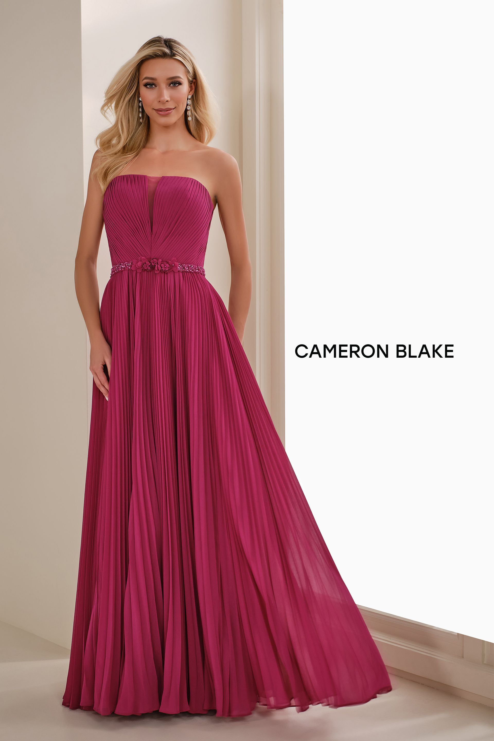 Woman in a magenta strapless gown; formal setting.