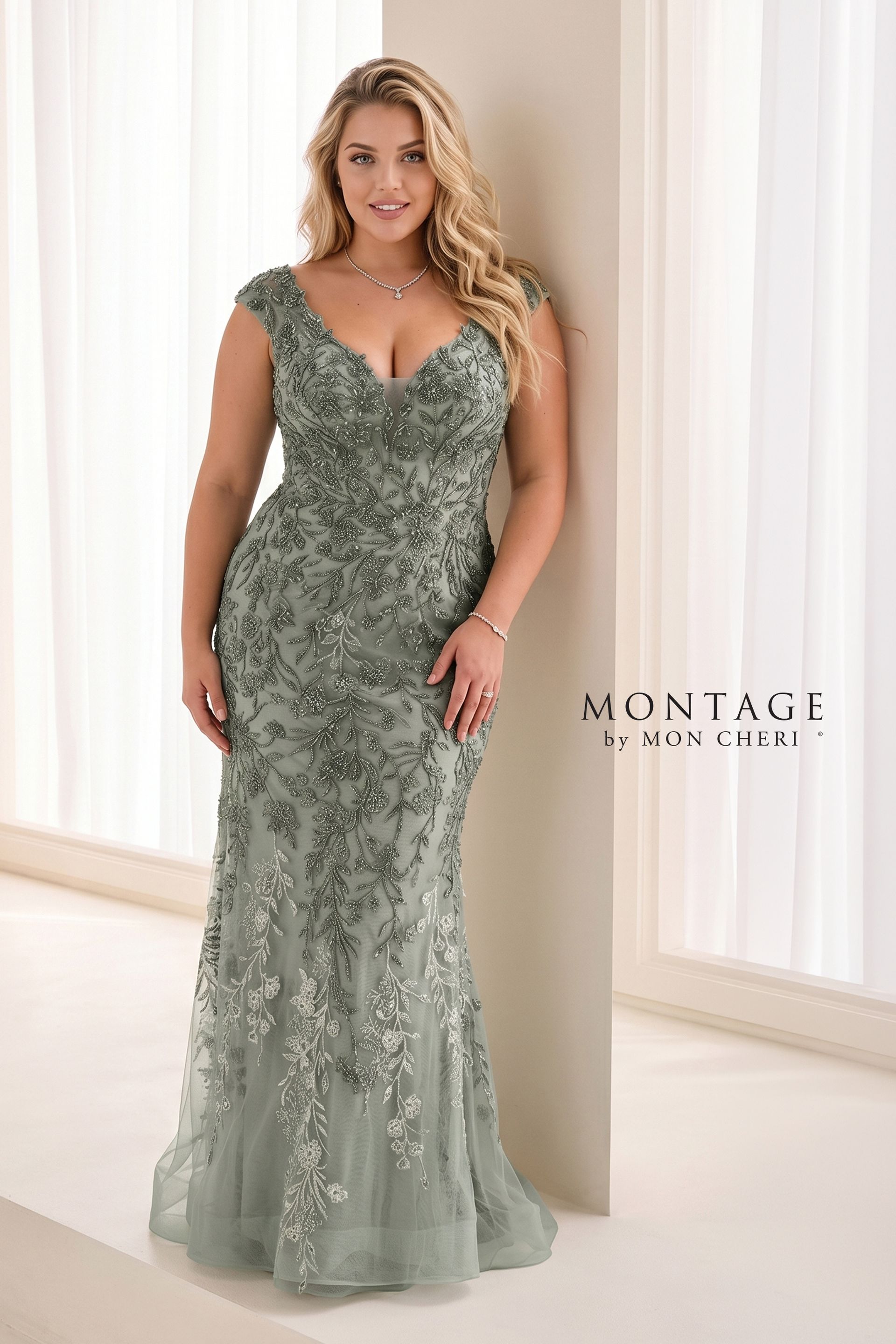 Woman in a silver beaded evening gown standing in a bright studio, with a MONTAIGE logo on the wall