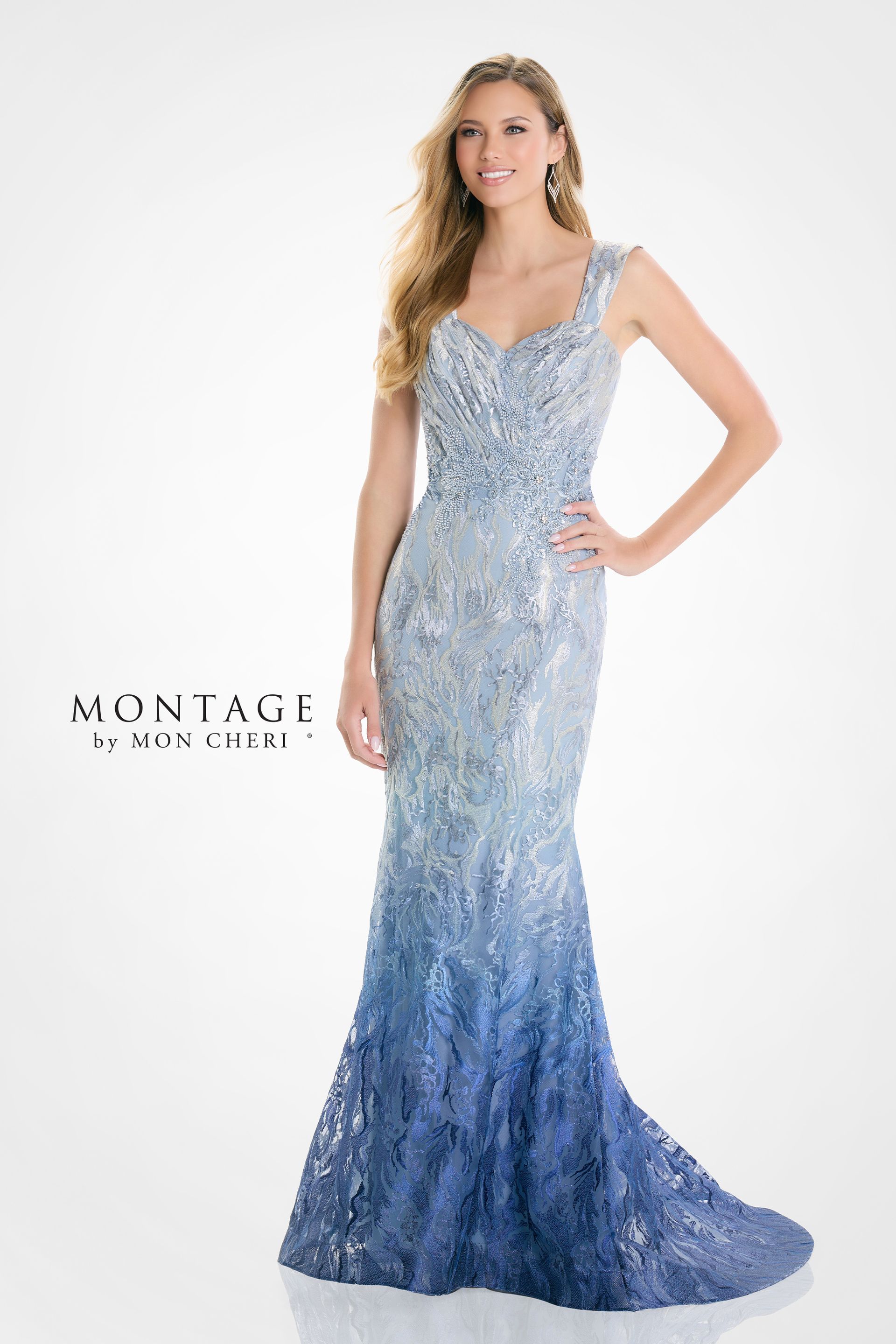 Woman in a sparkly blue ombre gown posing with hand on hip.