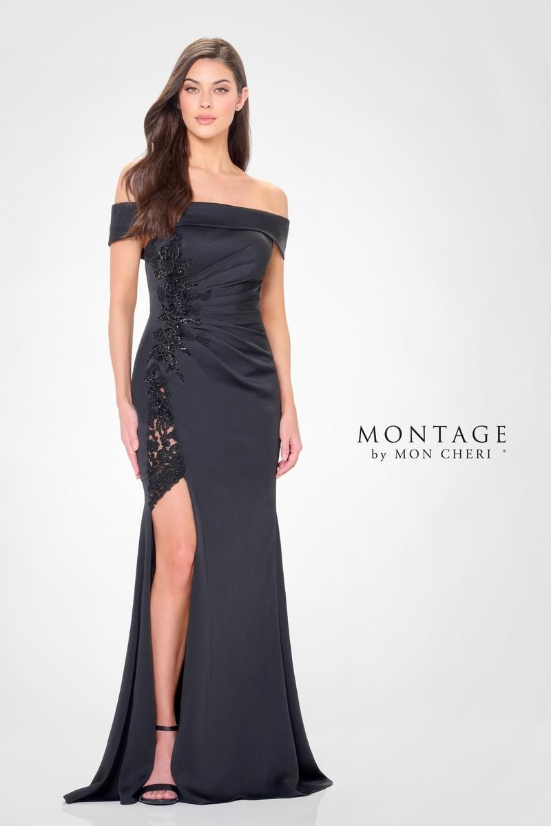 Woman in a navy off-the-shoulder gown with a high slit, standing against a white backdrop.