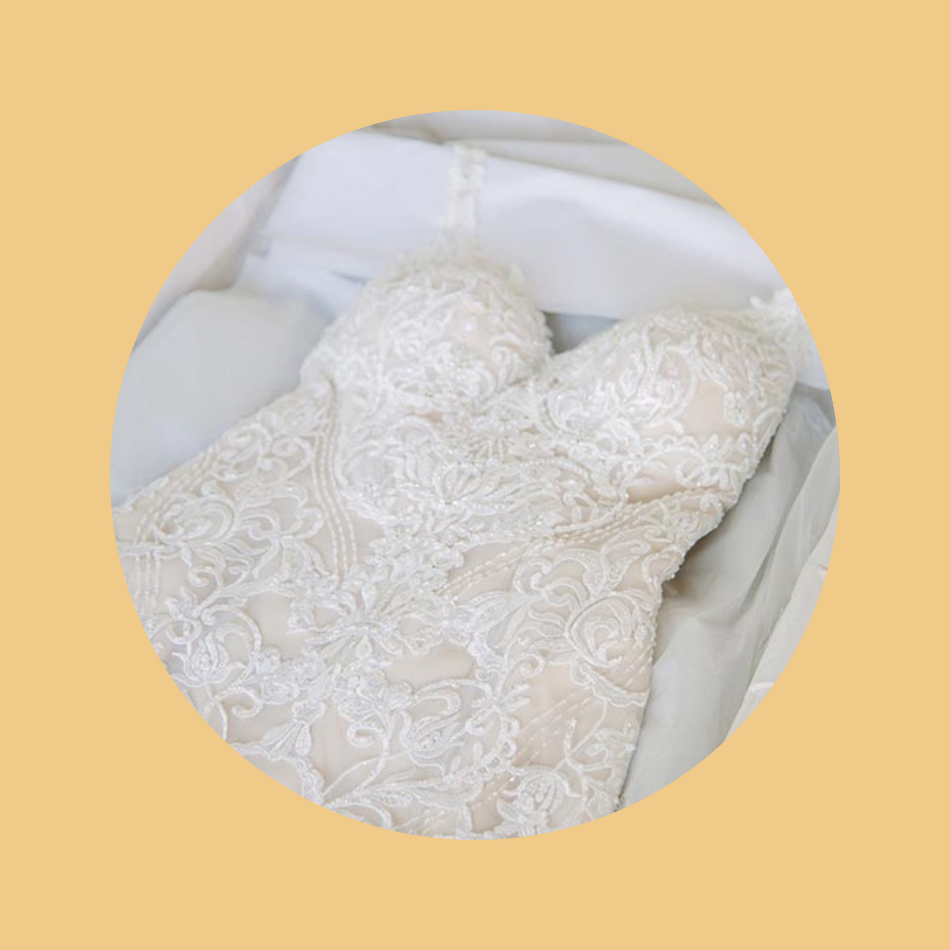 Strapless ivory wedding dress with lace detail on an off-white background.