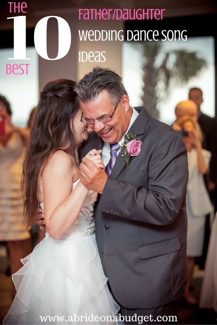 Father and daughter dancing at a wedding; the bride in white smiles as she dances with her father.