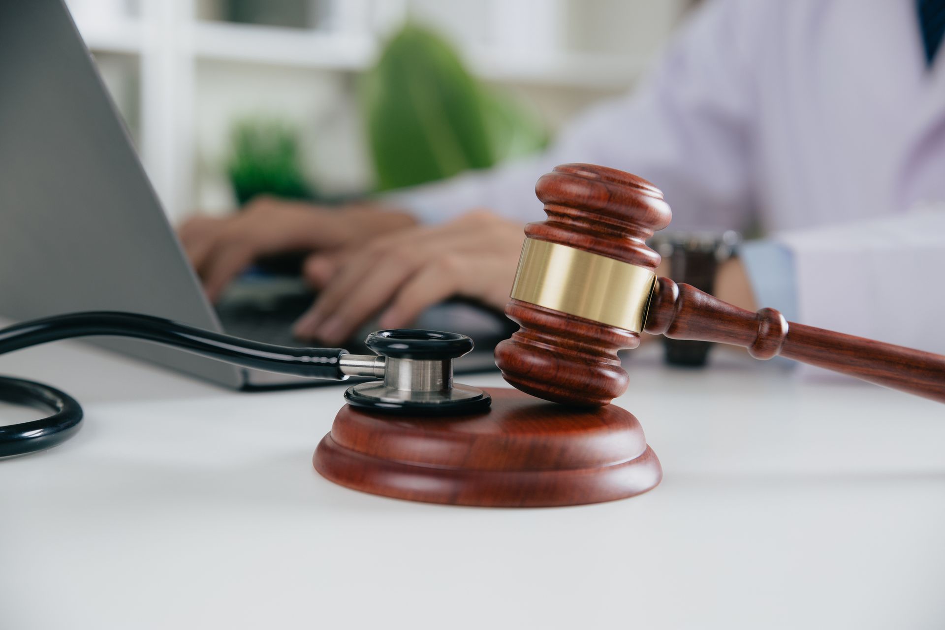 Personal injury attorney reviewing case files with client in a professional law office setting.