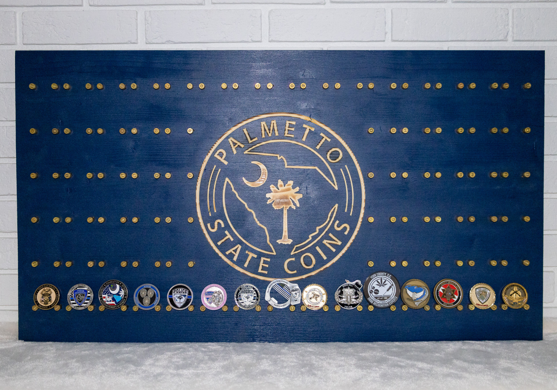 A blue coin display board with gold pins and a