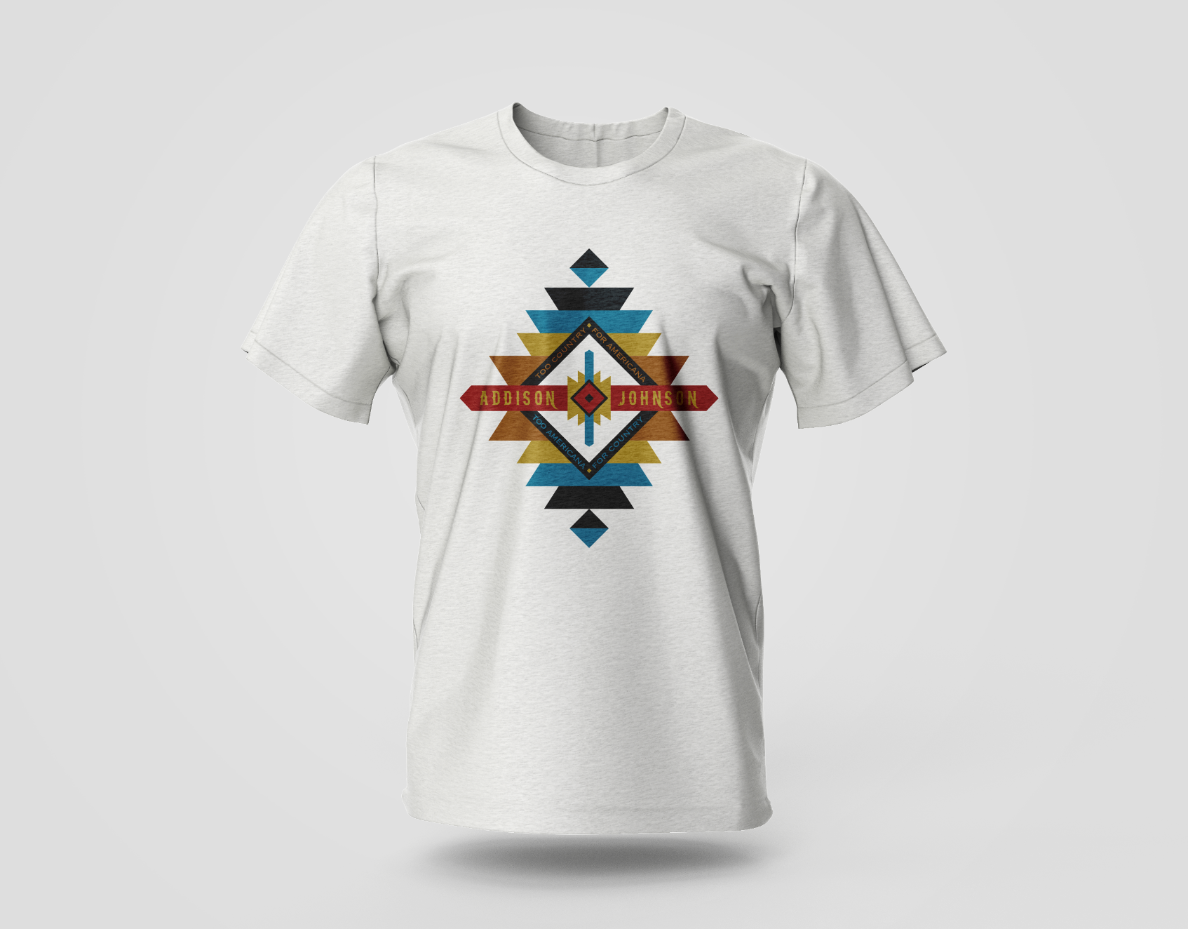 White t-shirt with a geometric diamond design in teal, brown, and gold.