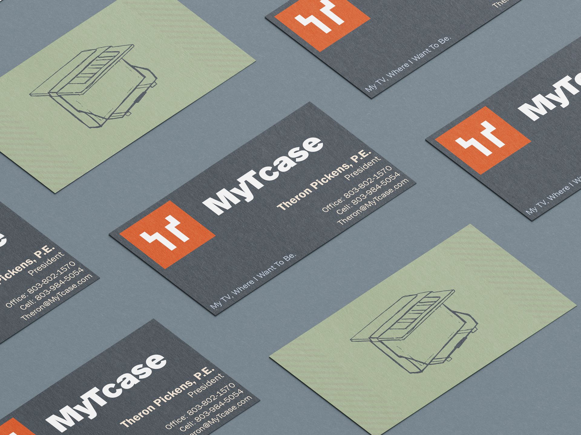 Business cards with a logo and contact information, arranged on a gray surface.