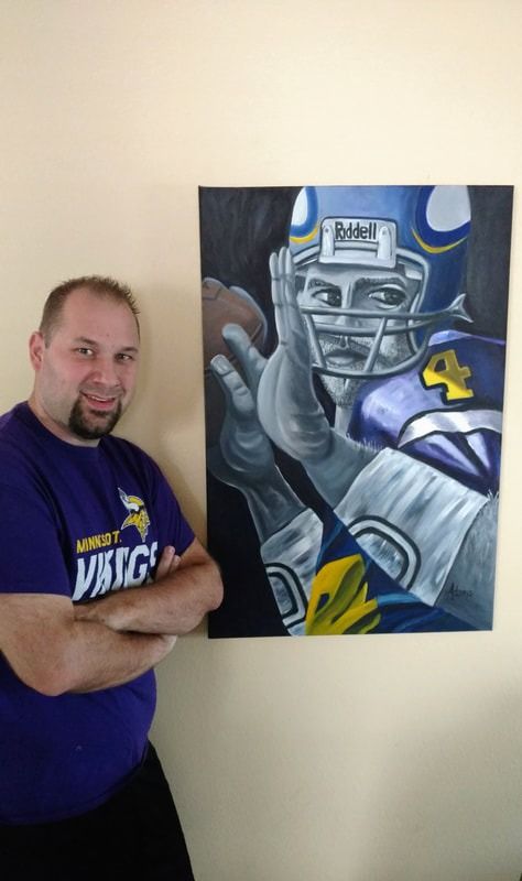 A man in a purple shirt is standing in front of a painting of a football player.