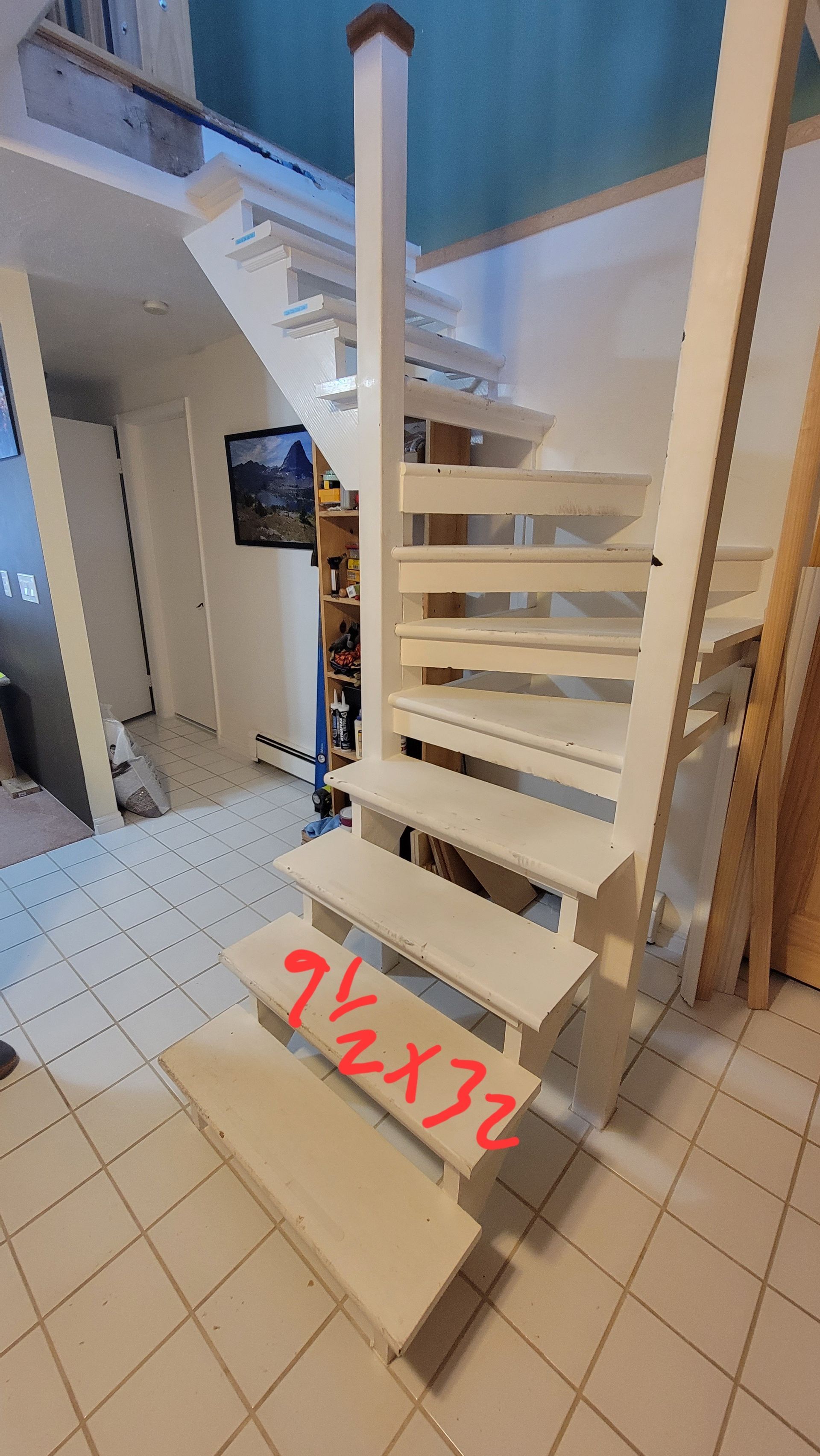 Wooden spiral staircase with white supports and light-colored steps, labeled 