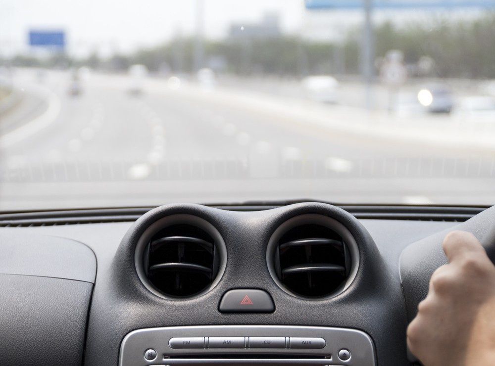 Inside a Car, Blurred View of Highway Ahead, Driver's Hand on Steering Wheel — ATD Automotive in North Wollongong, NSW