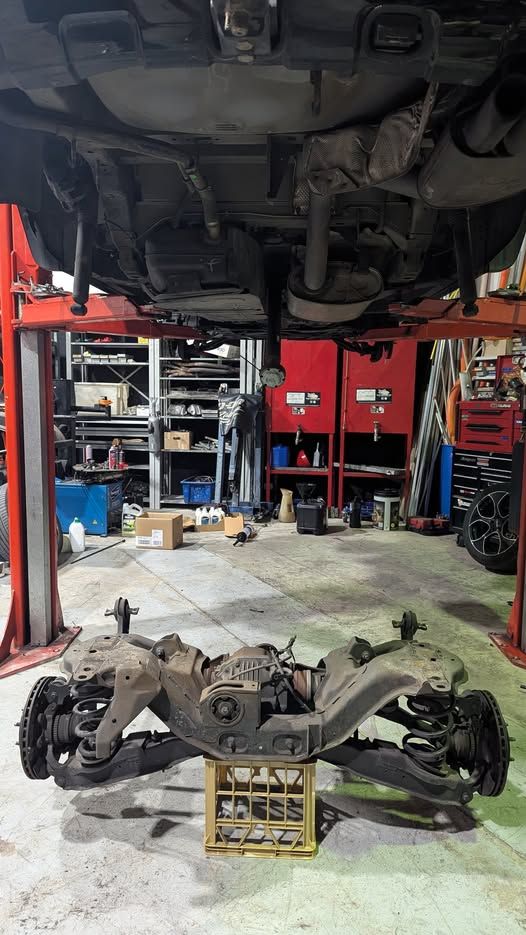 Car Raised on A Lift, Rear Suspension Assembly Detached and Resting on A Crate — ATD Automotive in North Wollongong, NSW