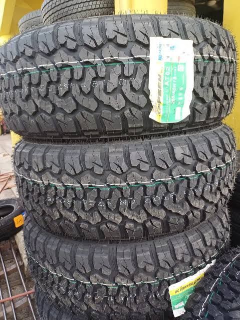 Four Black, Treaded Tires Stacked on Top of Each Other — ATD Automotive in North Wollongong, NSW