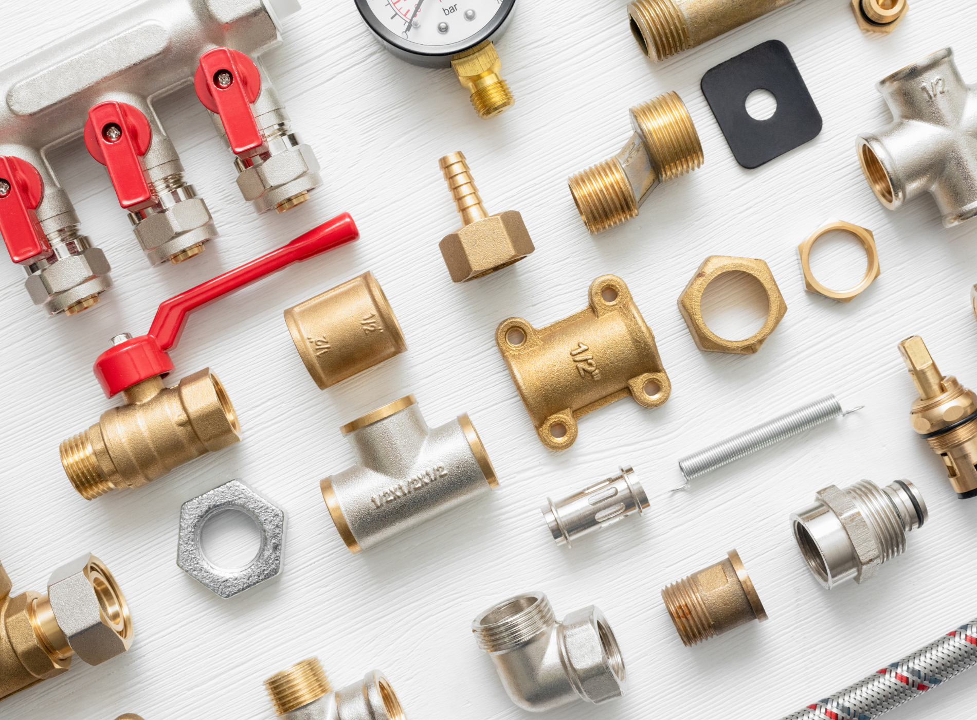 There are many different types of plumbing parts on the table.