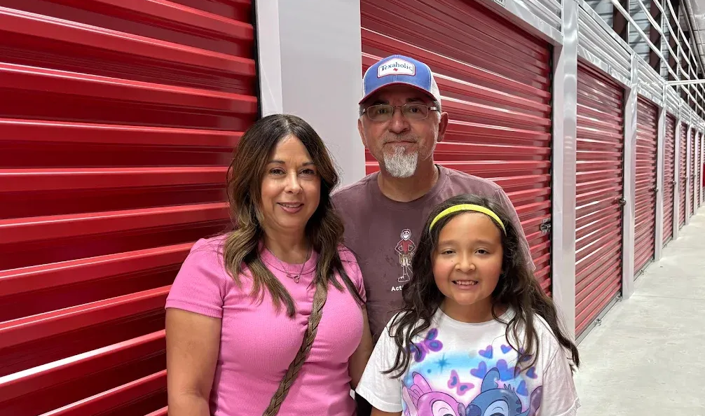 Happy family in front of Temple Star Storage units
