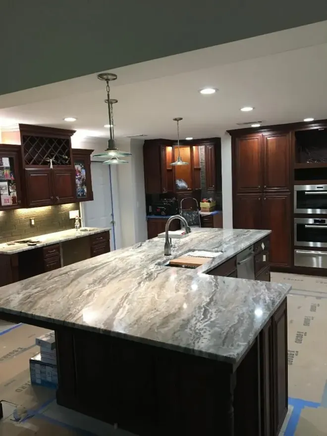 A kitchen with granite counter tops and stainless steel appliances