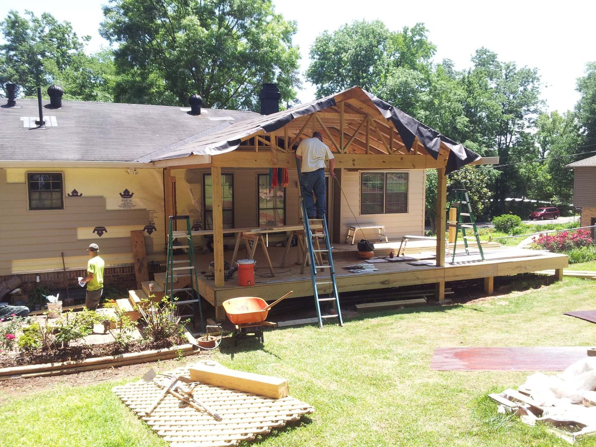 A house is being remodeled with a porch being built
