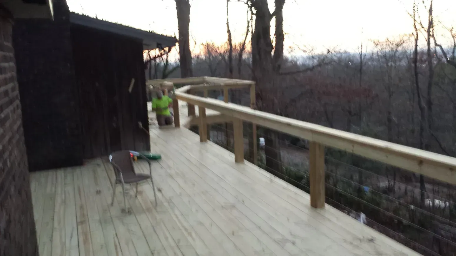 A wooden deck with a view of the woods